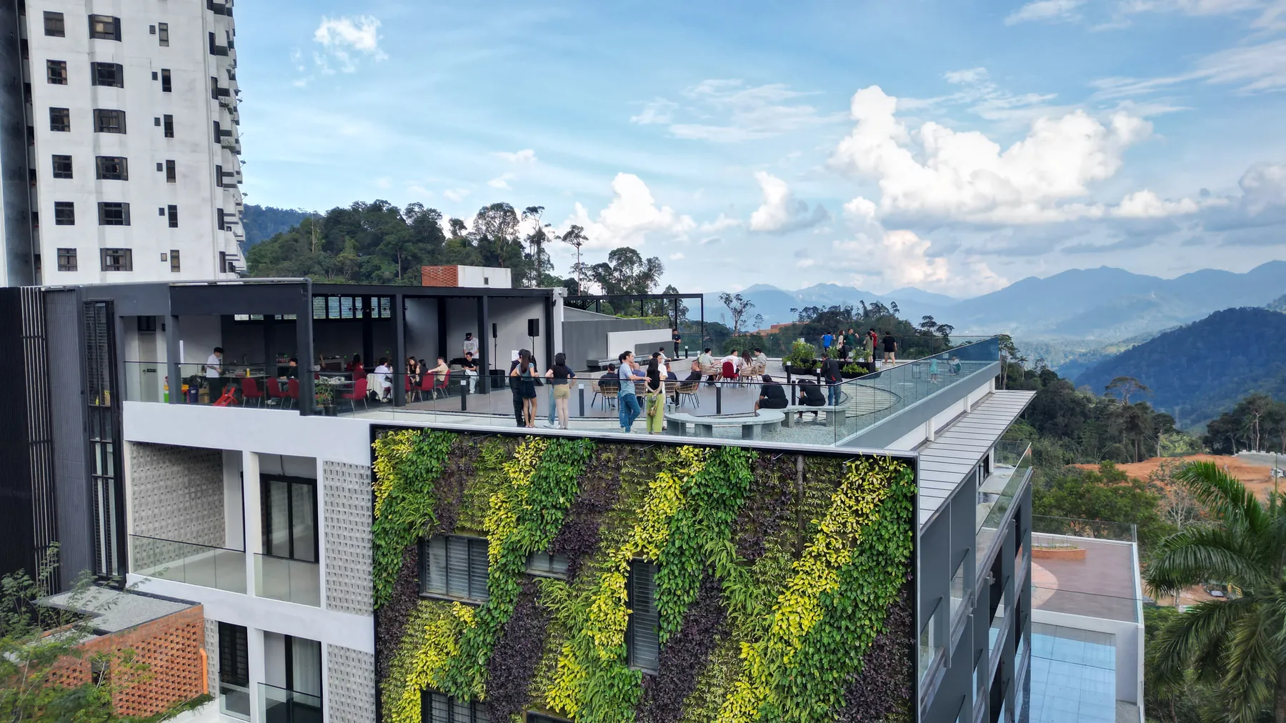 The planted facade of Block C with the roof terrace above